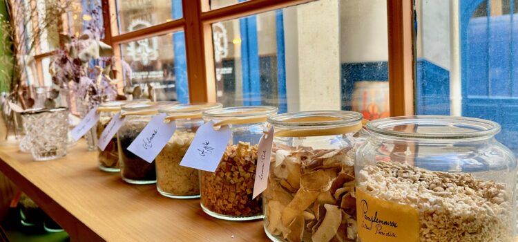 Row of botanicals in glass jars at a make your own gin workshop in Paris