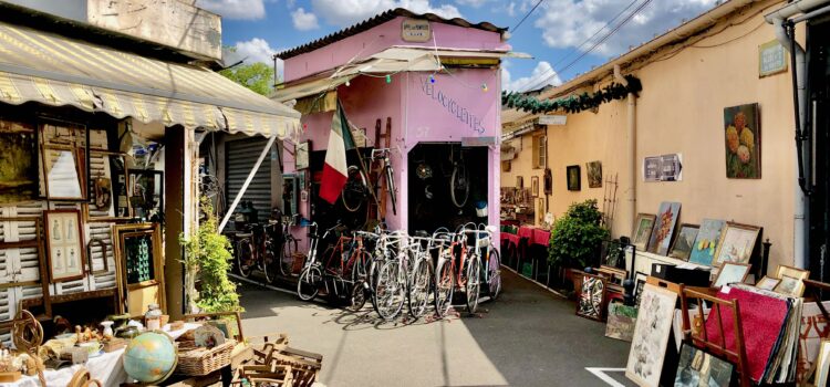 Bicycle shop, art vendor, and antiques on display in the marché vernaison, one of the open-air markets at the Paris Saint-Ouen flea market