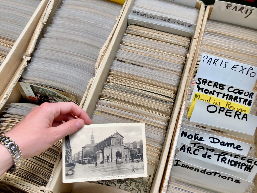 Narrow boxes filled with vintage postcards at the marché aux puces de Saint-Ouen