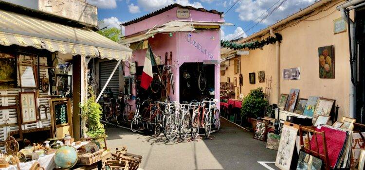 Paris Saint-Ouen Flea Market Guide: What to Expect Bicycle shop, art vendor, and antiques on display in the marché vernaison, one of the open-air markets at the Paris Saint-Ouen flea market
