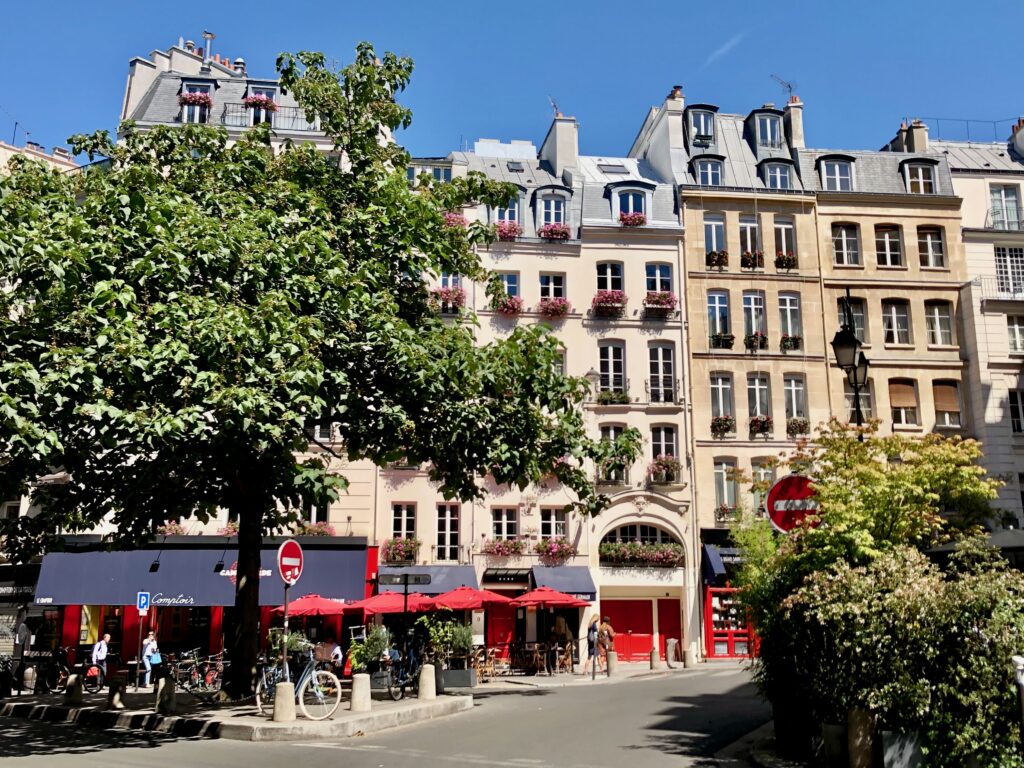 Paris fa&ccedil;ade in full sun in July. Buildings have zinc rooftops.