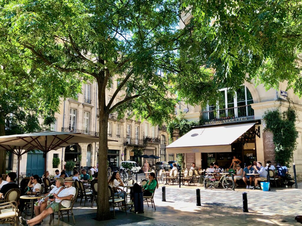 French people enjoying an outdoor seating area terrasse in Bordeaux, France.